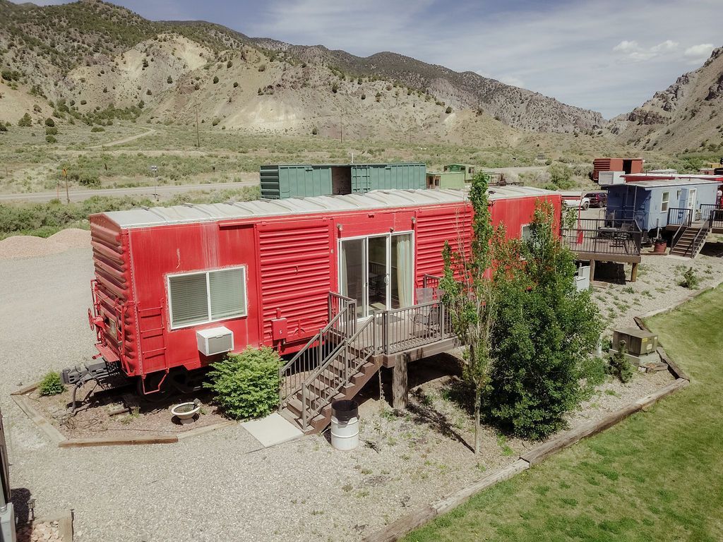 An aerial view of a red train car with stairs leading up to it.