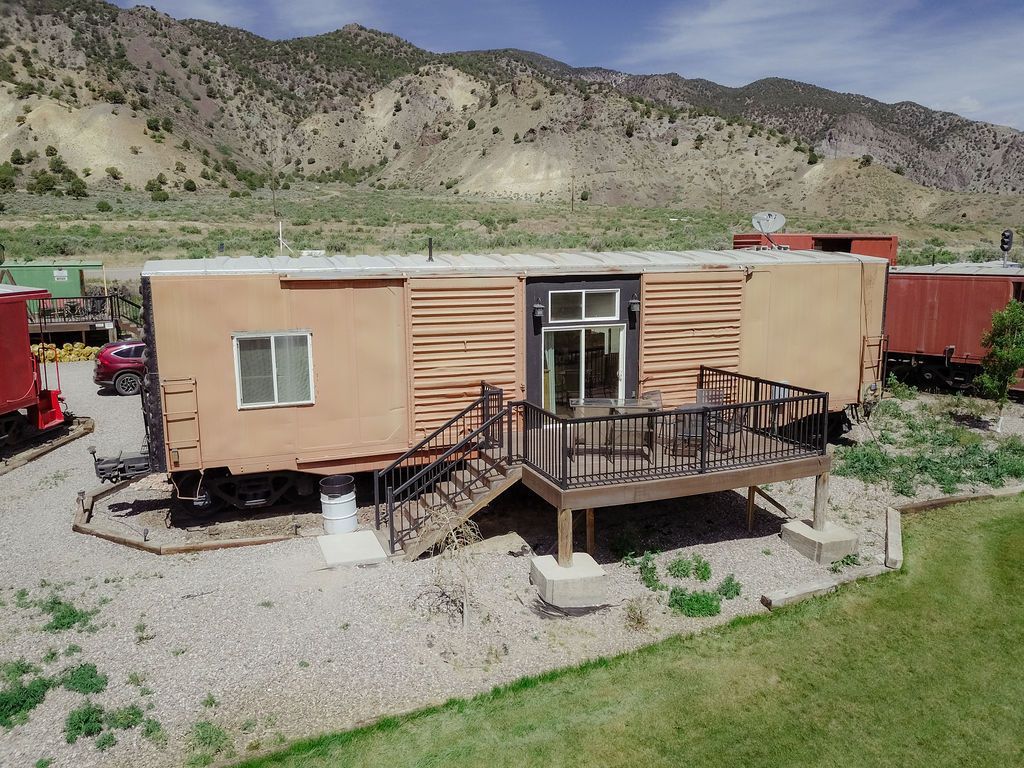 An aerial view of a trailer with a deck and stairs.