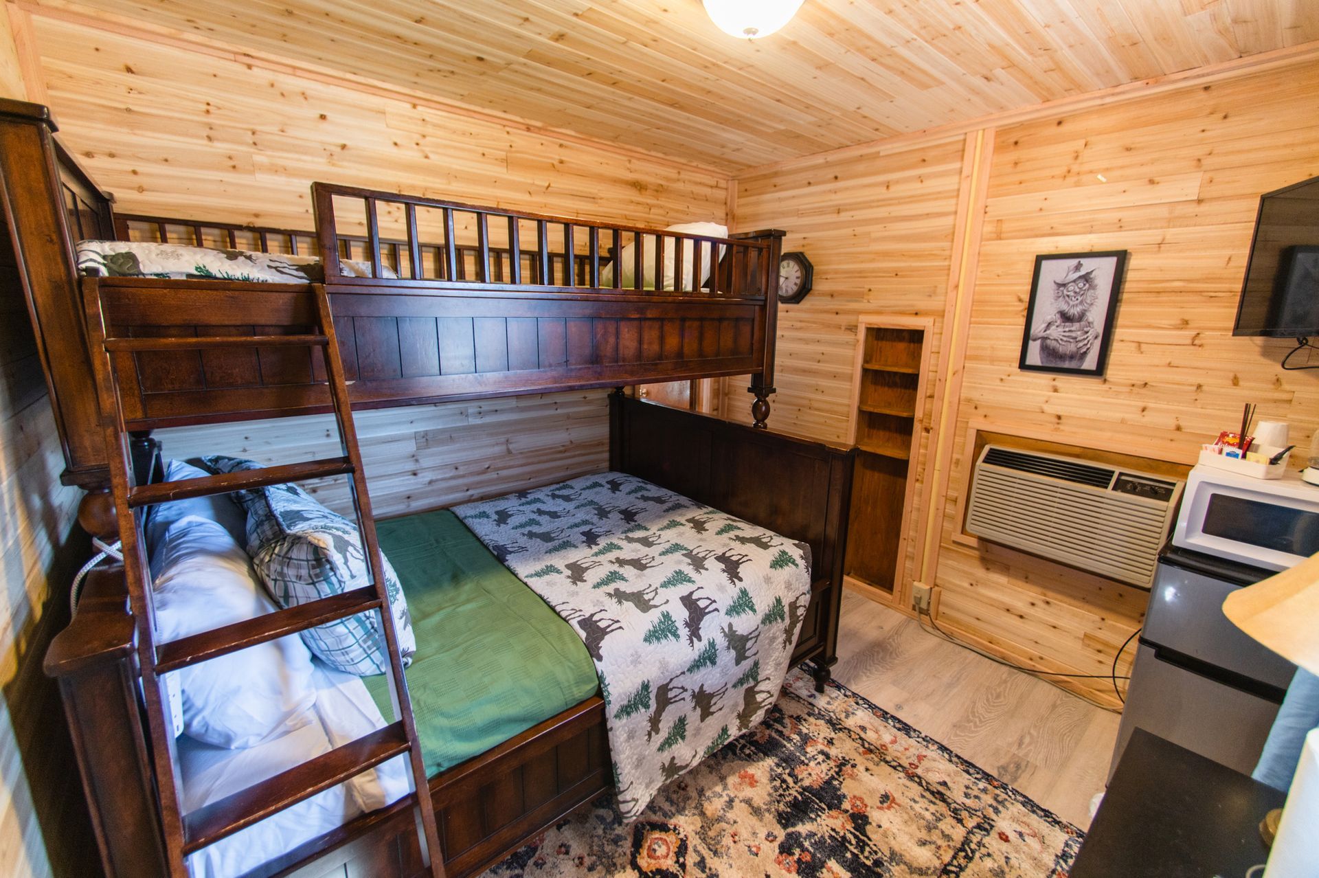 A bedroom with a bunk bed and a ladder.