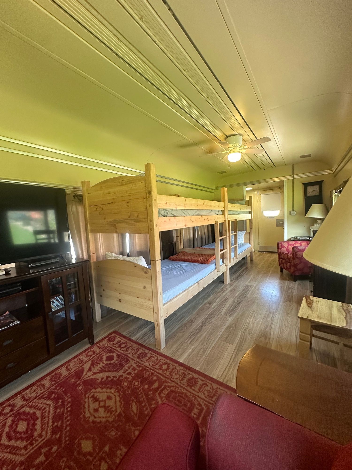 A living room with bunk beds and a television.