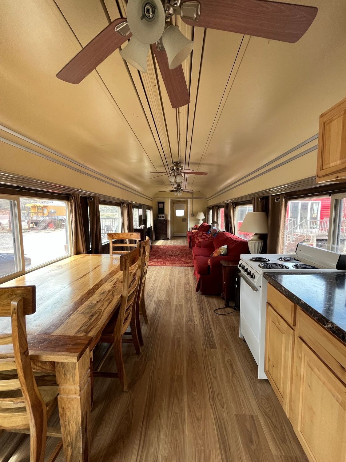 A kitchen with a table and chairs and a ceiling fan