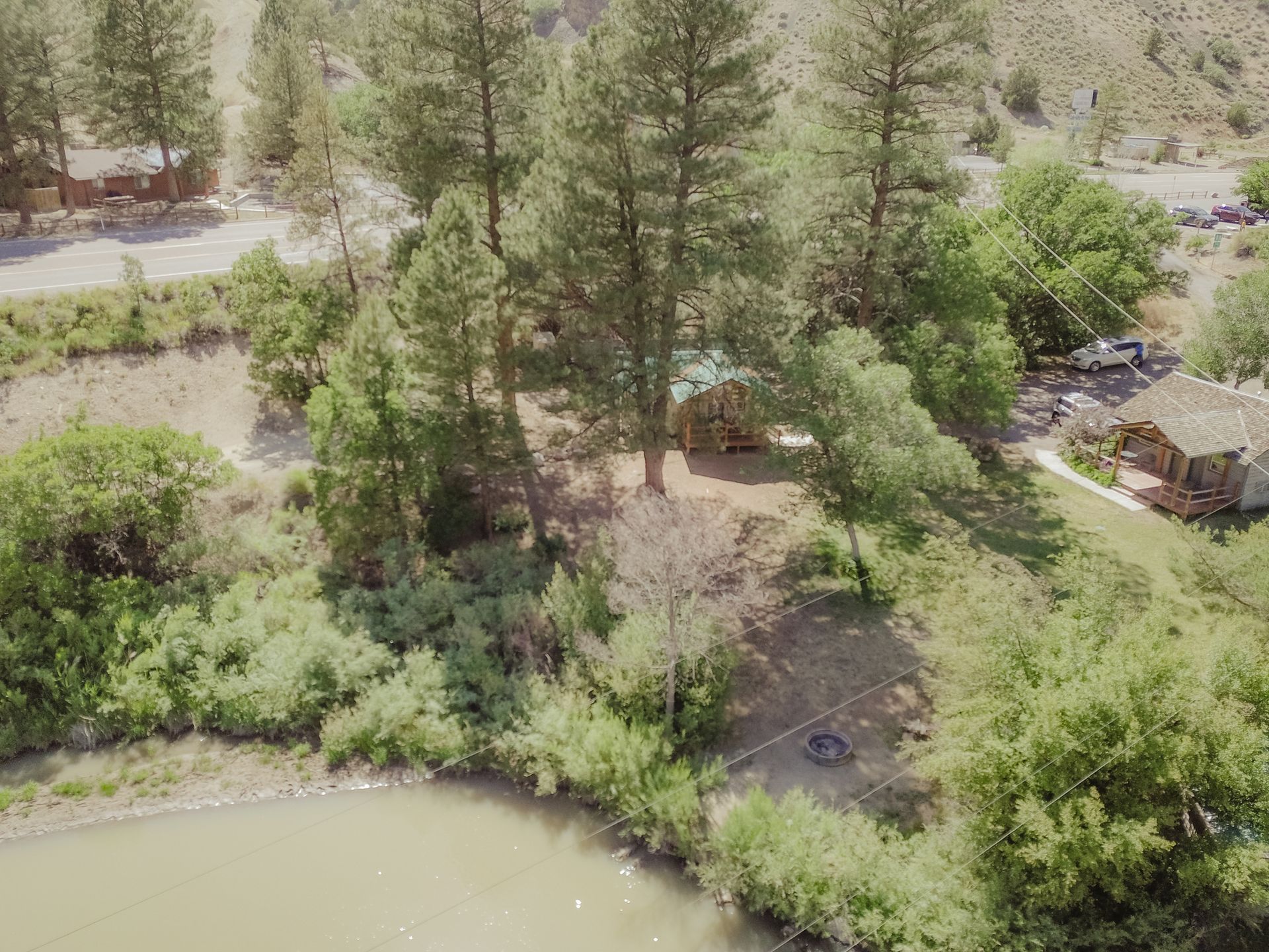 An aerial view of a river surrounded by trees and houses.