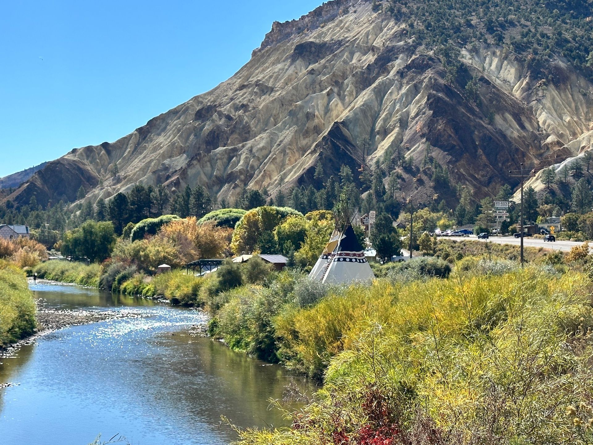 A river runs through a valley with mountains in the background