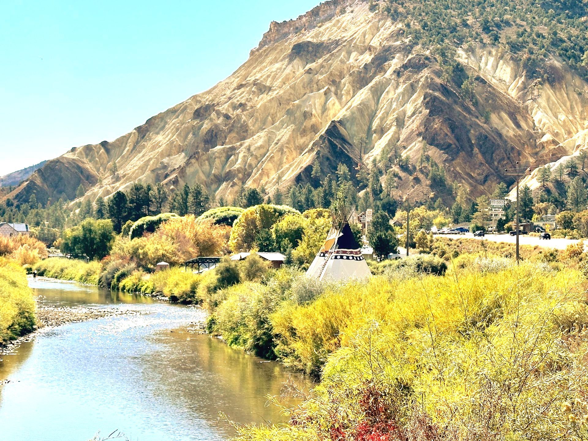 A river runs through a valley with mountains in the background.