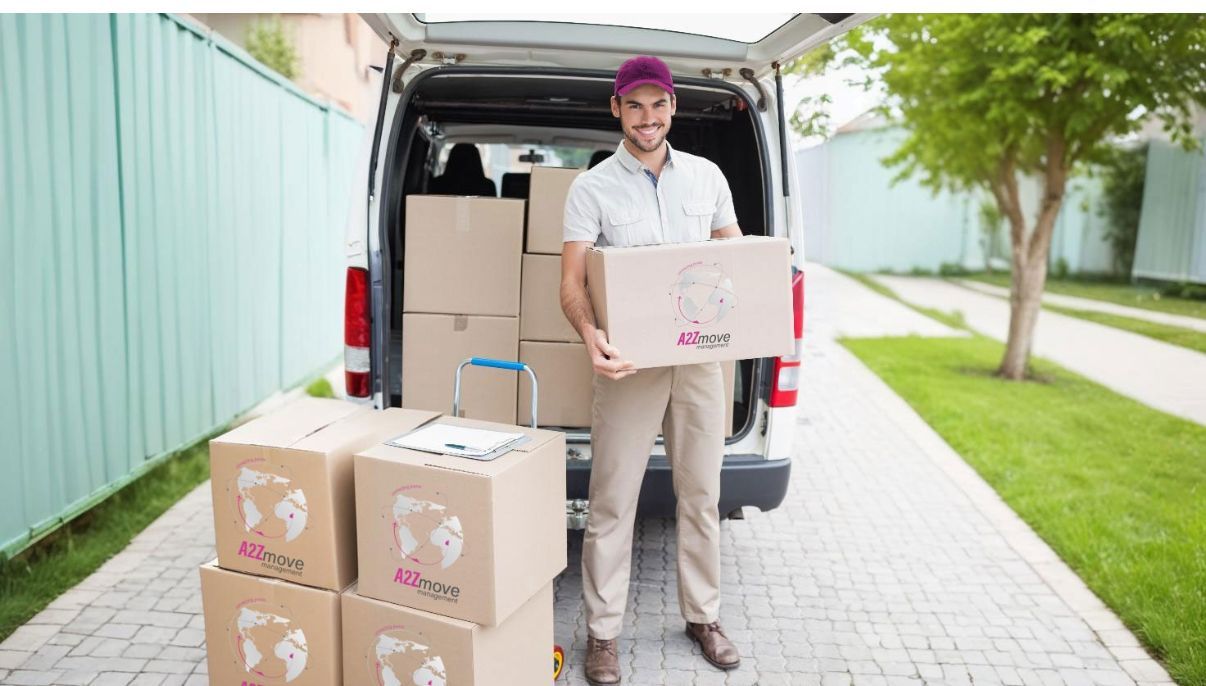 A delivery man is holding a box in front of a van filled with boxes.