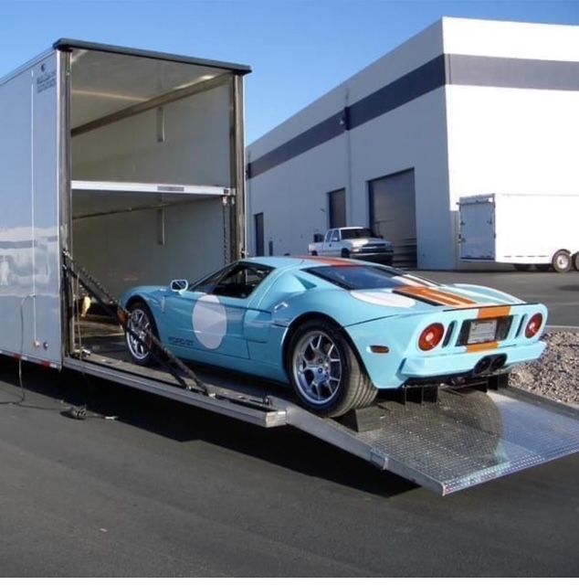 A gulf car is being loaded into a trailer