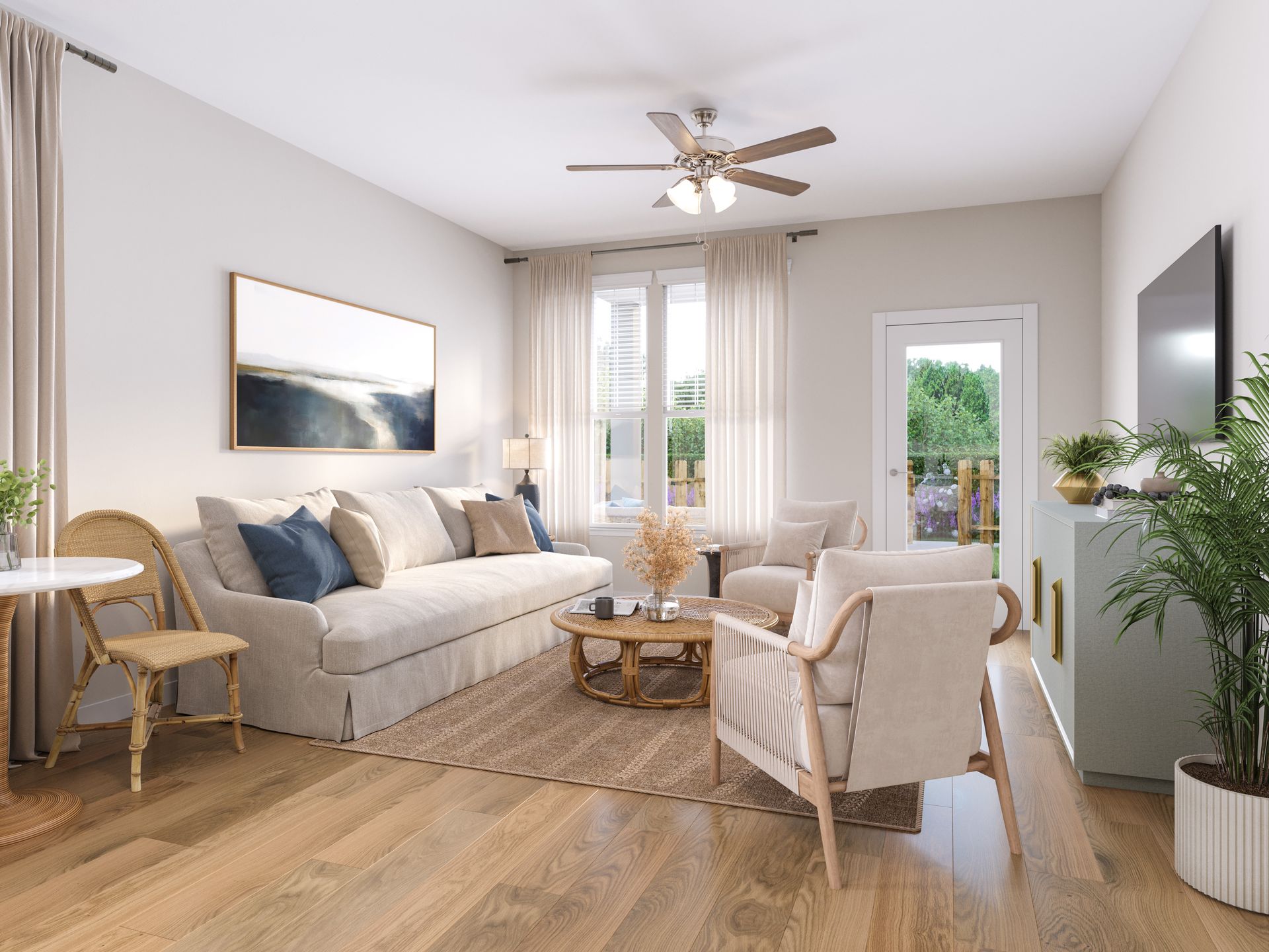 A bright, airy living room with a beige sofa, two armchairs, a wooden coffee table, a ceiling fan, and a large window.