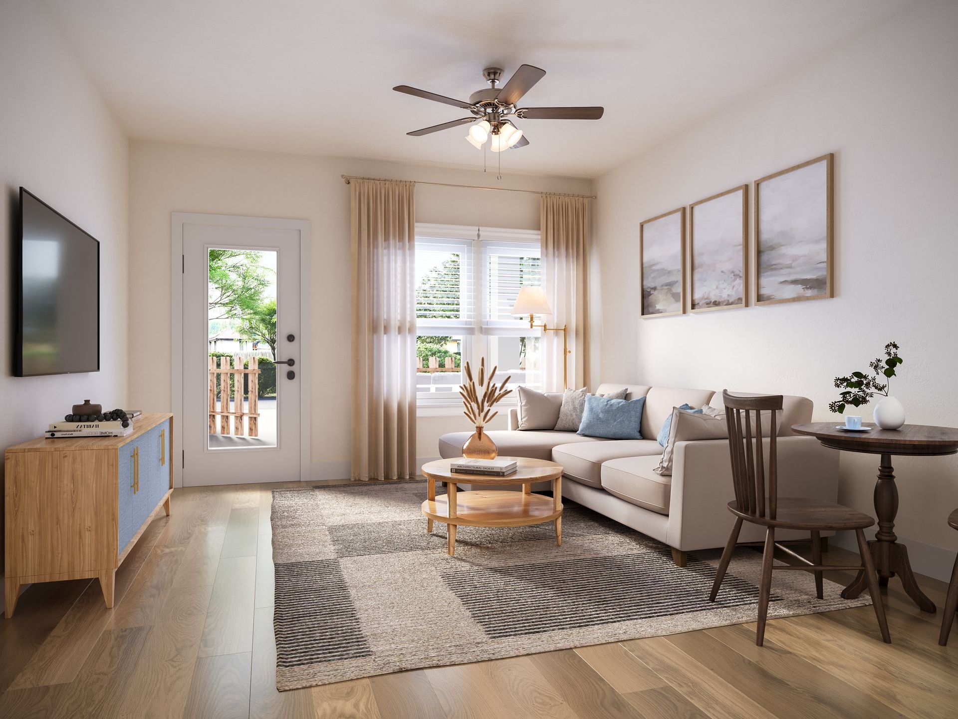 A modern living room with a neutral sectional sofa, round coffee table, area rug, TV console, and a dining table.