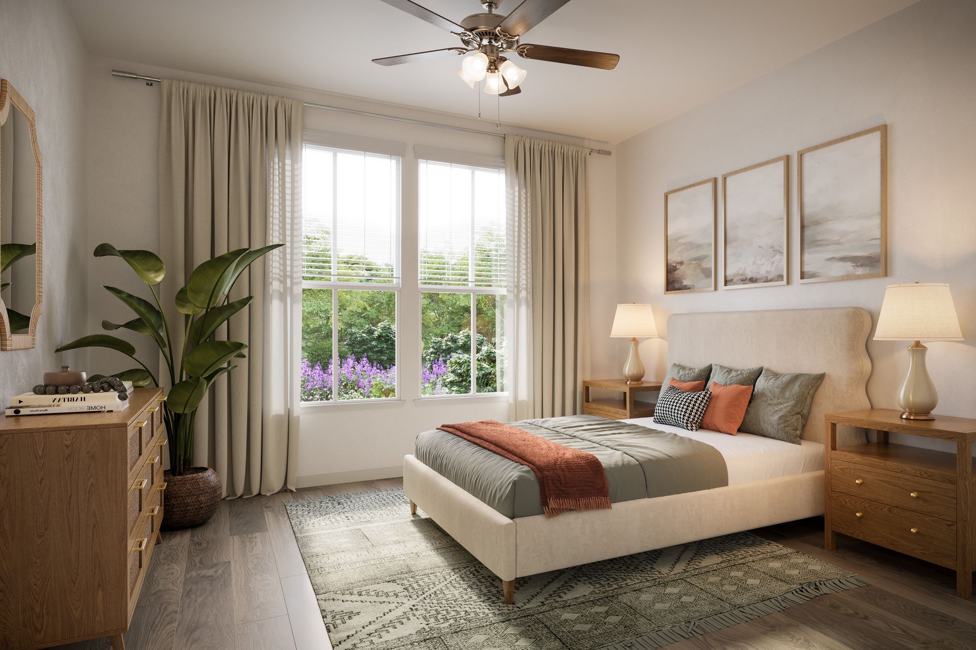 A well-lit, neutral-toned bedroom with a beige upholstered bed, wooden furniture, a large plant, and three wall prints.