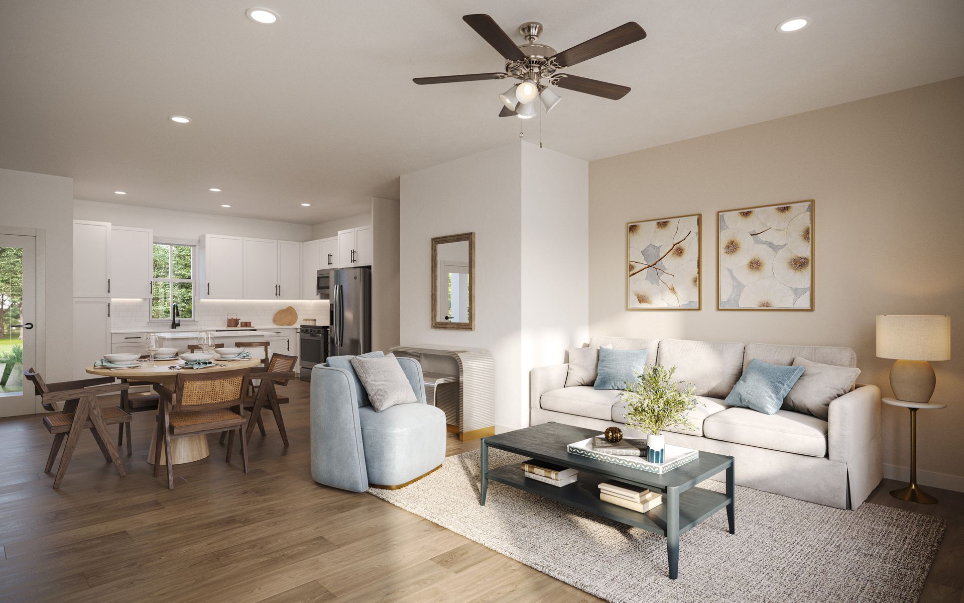 A living and dining area with a sofa, armchair, coffee table, and open kitchen in a modern, neutral-toned home.