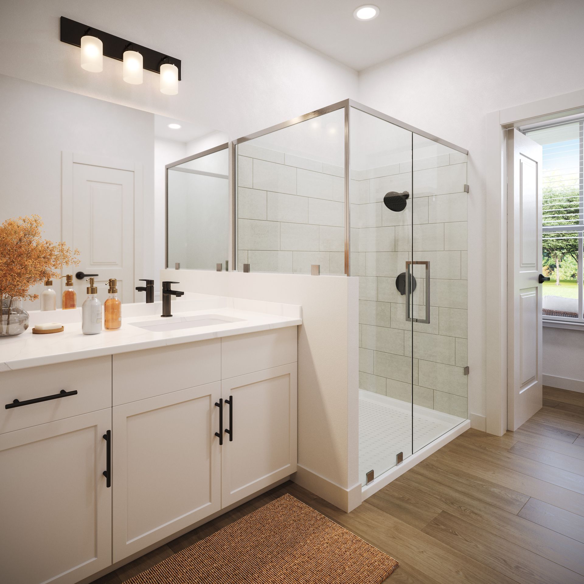 A bright, modern bathroom featuring a white vanity with black hardware, a glass-enclosed shower, and wood-look flooring.