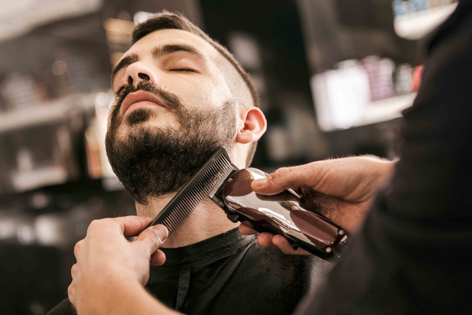 Man Getting His Beard Trimmed With Electric Razor At Hairdresser — Omaha, NE — Hair By Markiesha