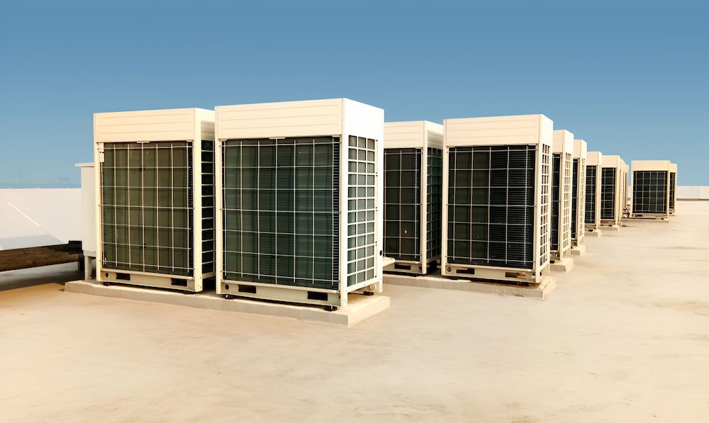 A Row Of Air Conditioners Sitting On Top Of A Roof — BT Airconditioning In Portsmith, QLD
