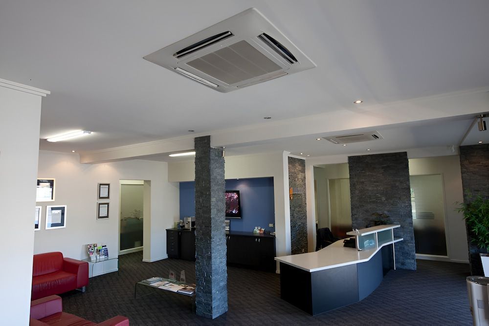 A Large Room With A Ceiling Fan And A Reception Desk — BT Airconditioning In Portsmith, QLD
