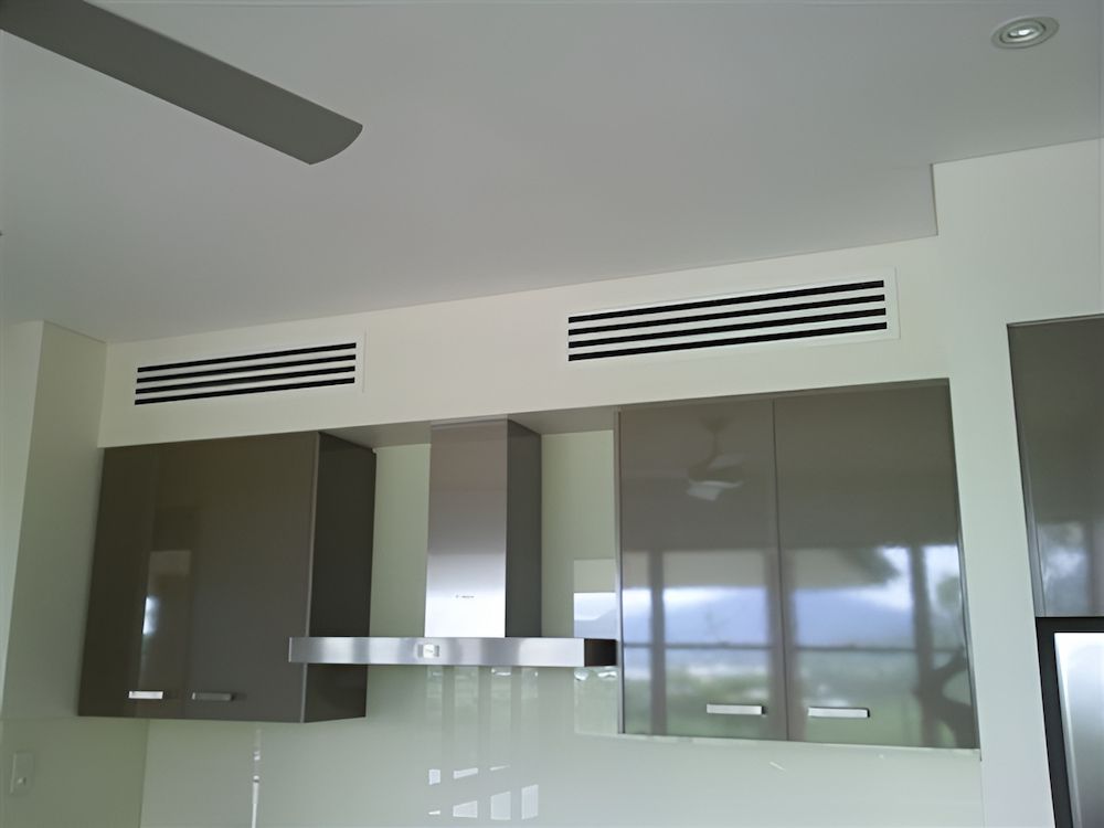 A Kitchen With Stainless Steel Cabinets And Aircondition— BT Airconditioning In Portsmith, QLD