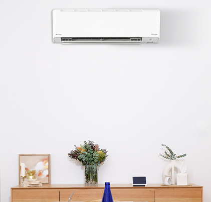 A Person Is Holding A Remote Control — BT Airconditioning In Edmonton, QLD