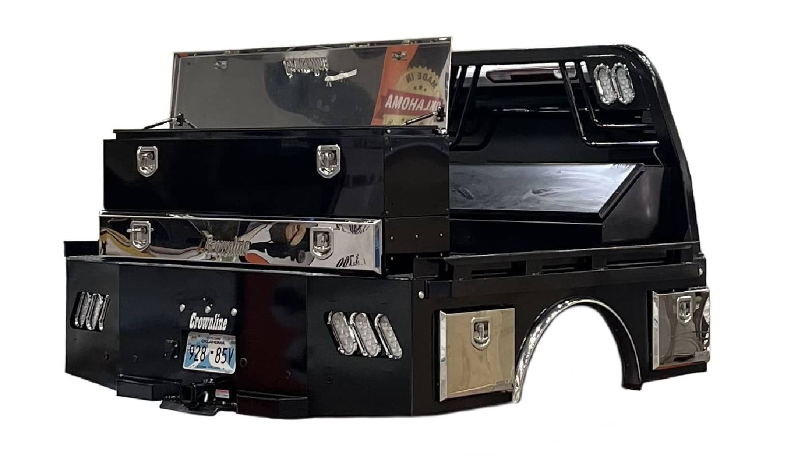 A black truck bed with a stainless steel toolbox on top of it.