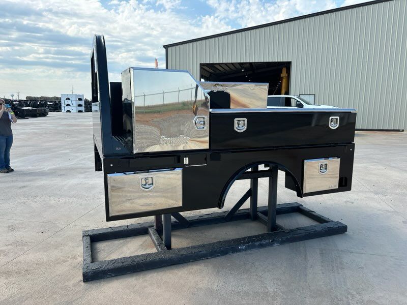 A truck flatbed with stainless steel toolbox drawers.