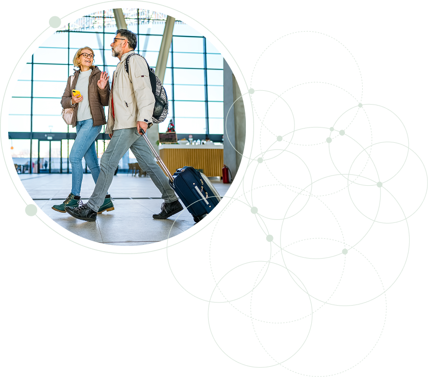 Couple walking through airport, excited for their trip