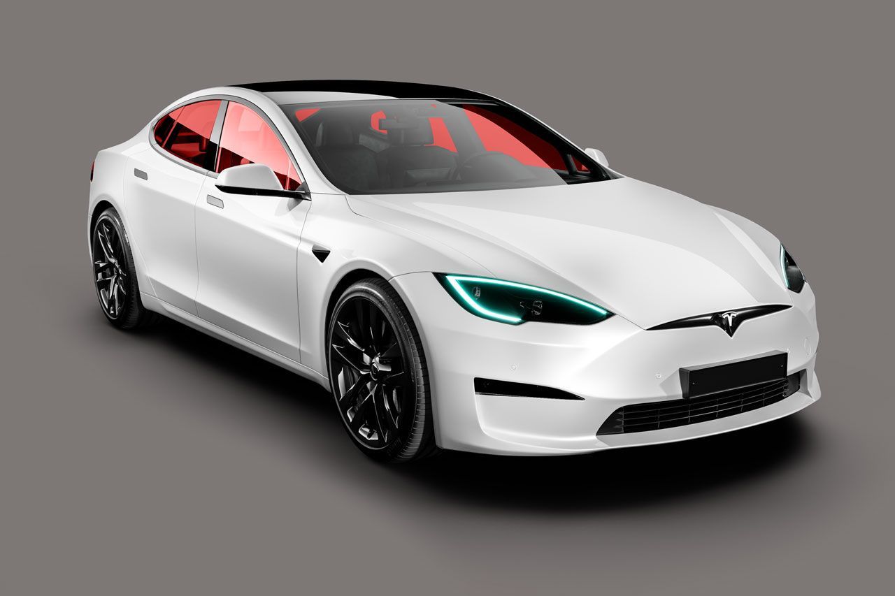 a white tesla model s is sitting on a gray surface .