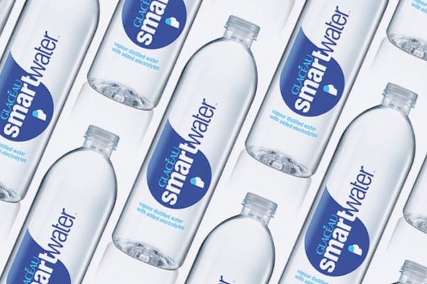 Several bottles of smartwater are lined up in a row