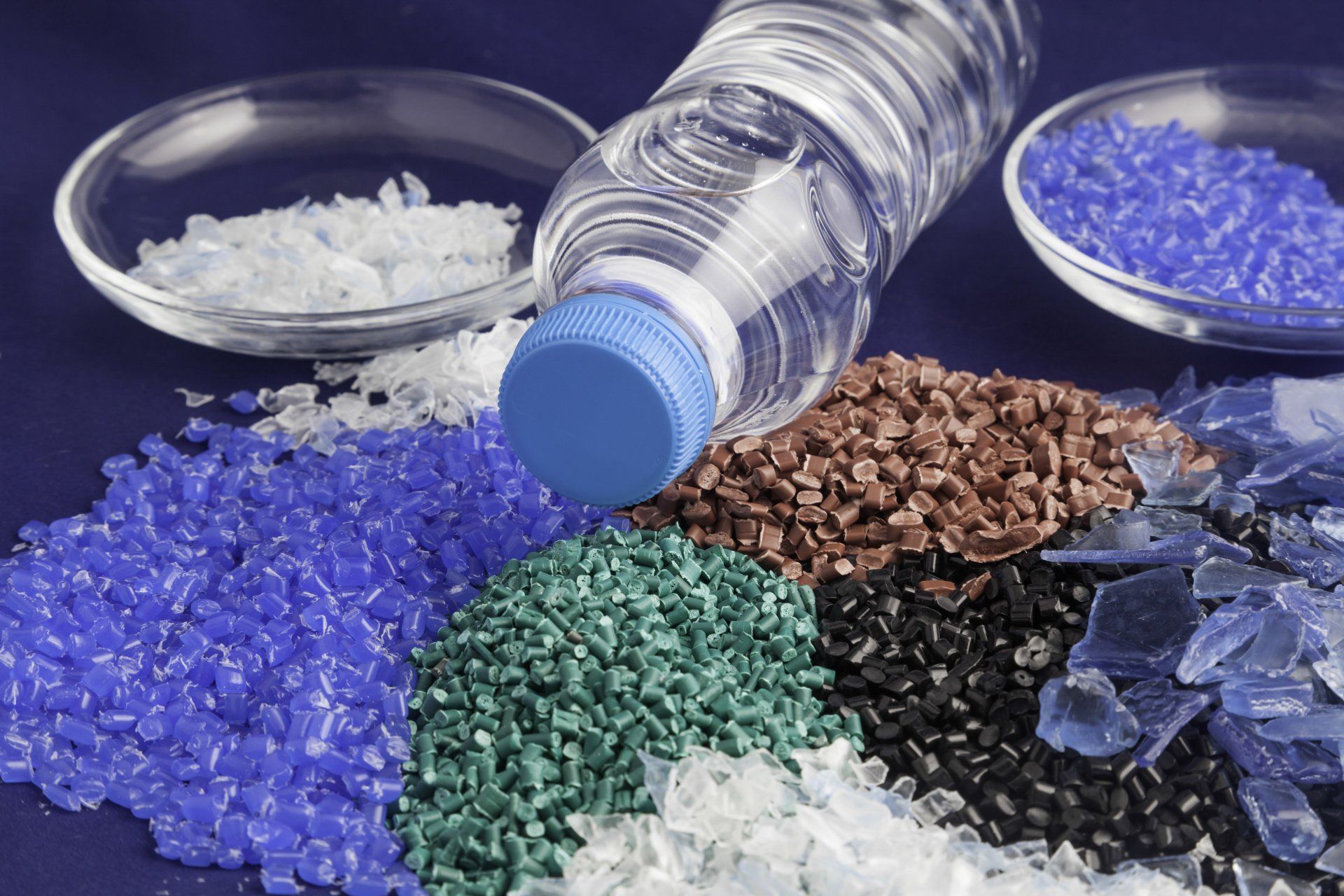 Recycled plastic granules of various colors.