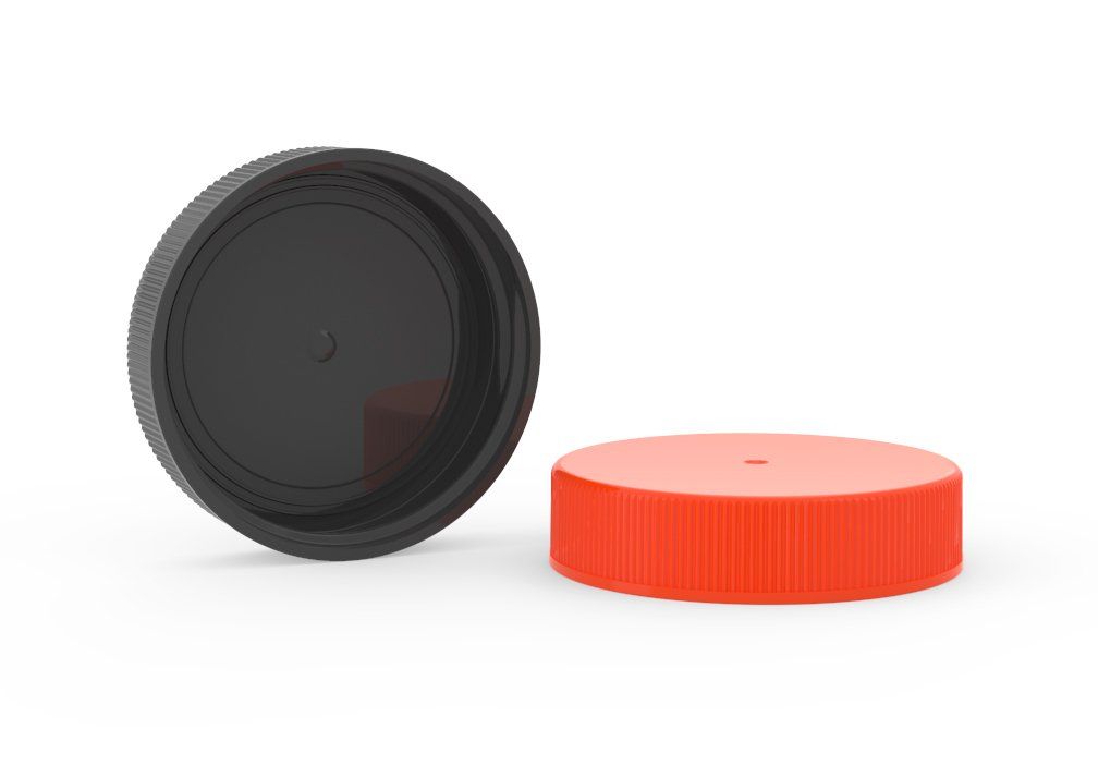 A black plastic cap and a red plastic cap on a white background.