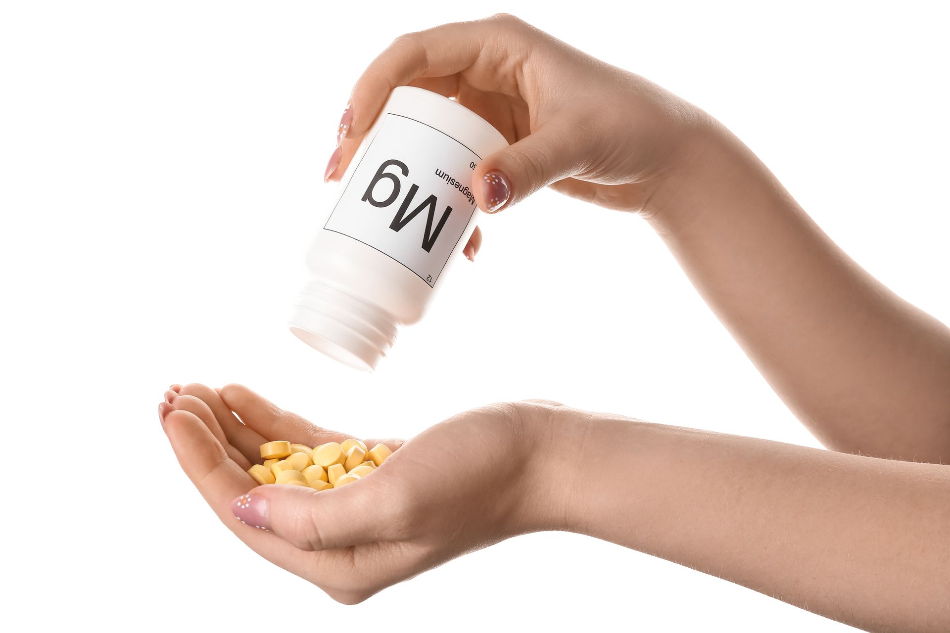 A woman is pouring pills from a bottle into her hand.