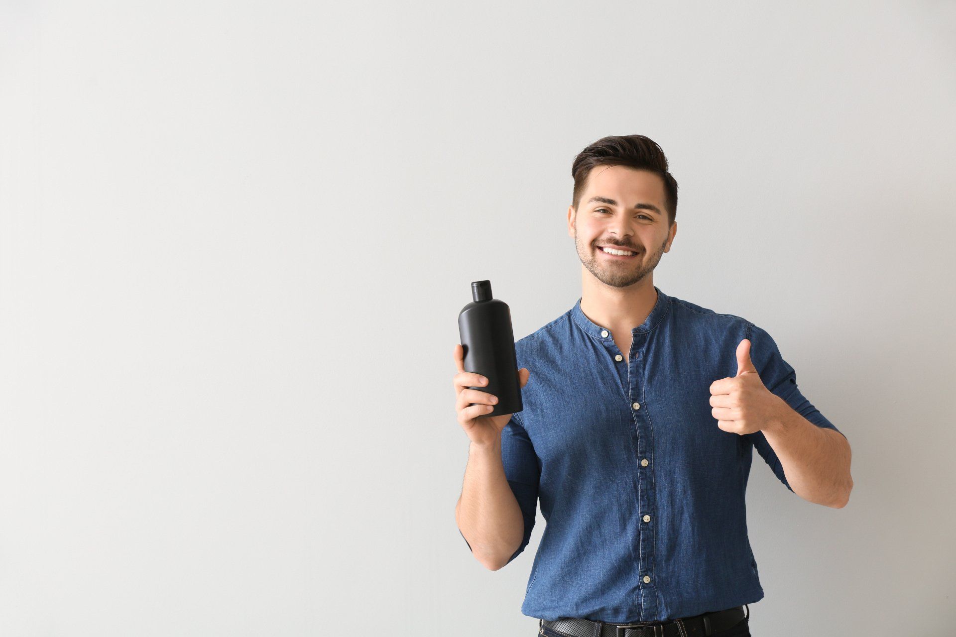 man with oval shampoo bottle