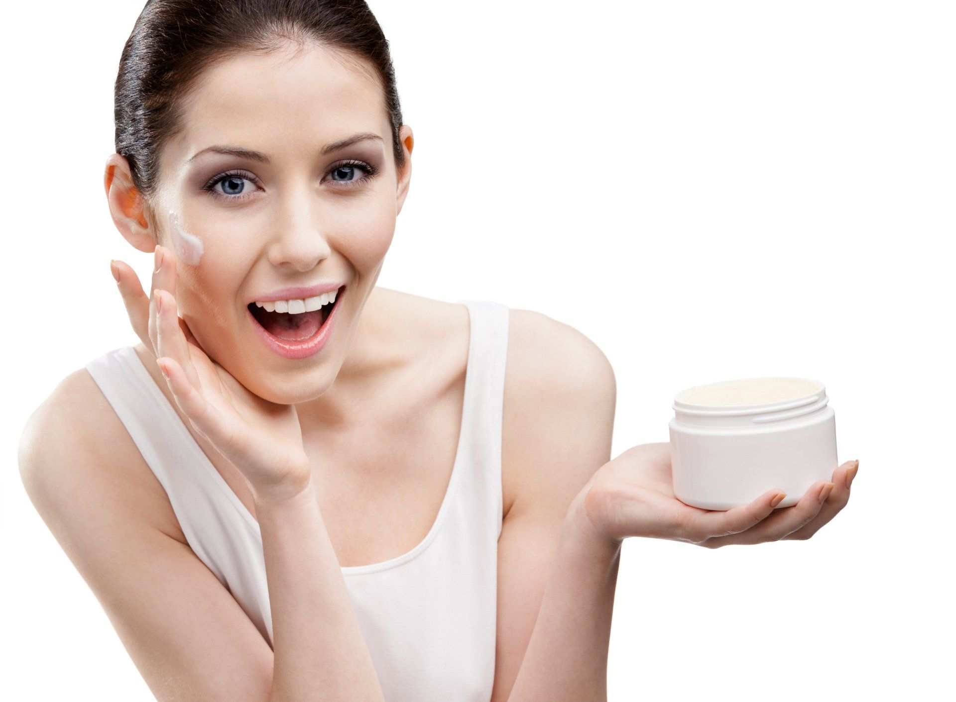 attractive woman in a white tank applying skin cream to her face