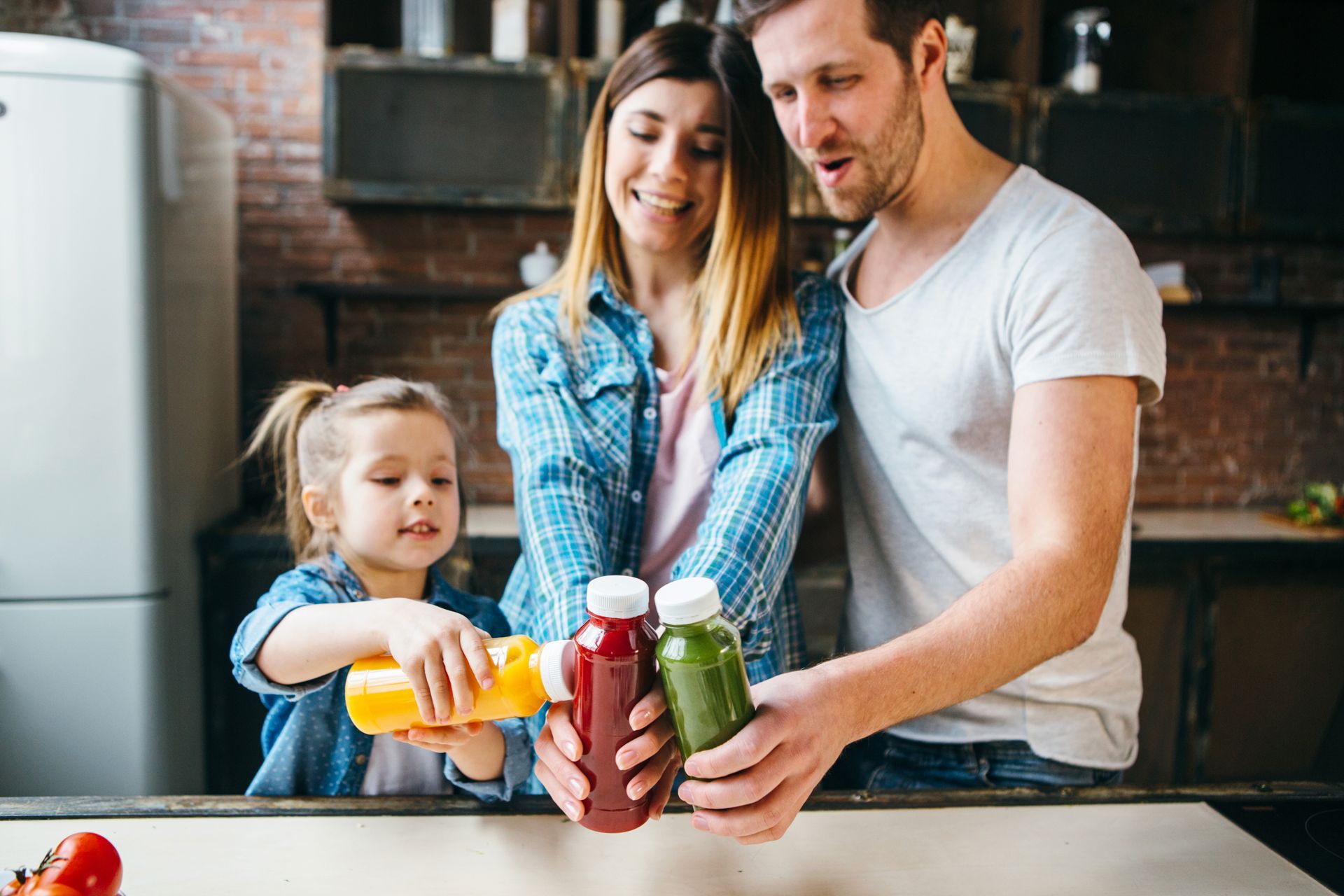A family enjoying cold-pressed juice in PET plastic bottles.