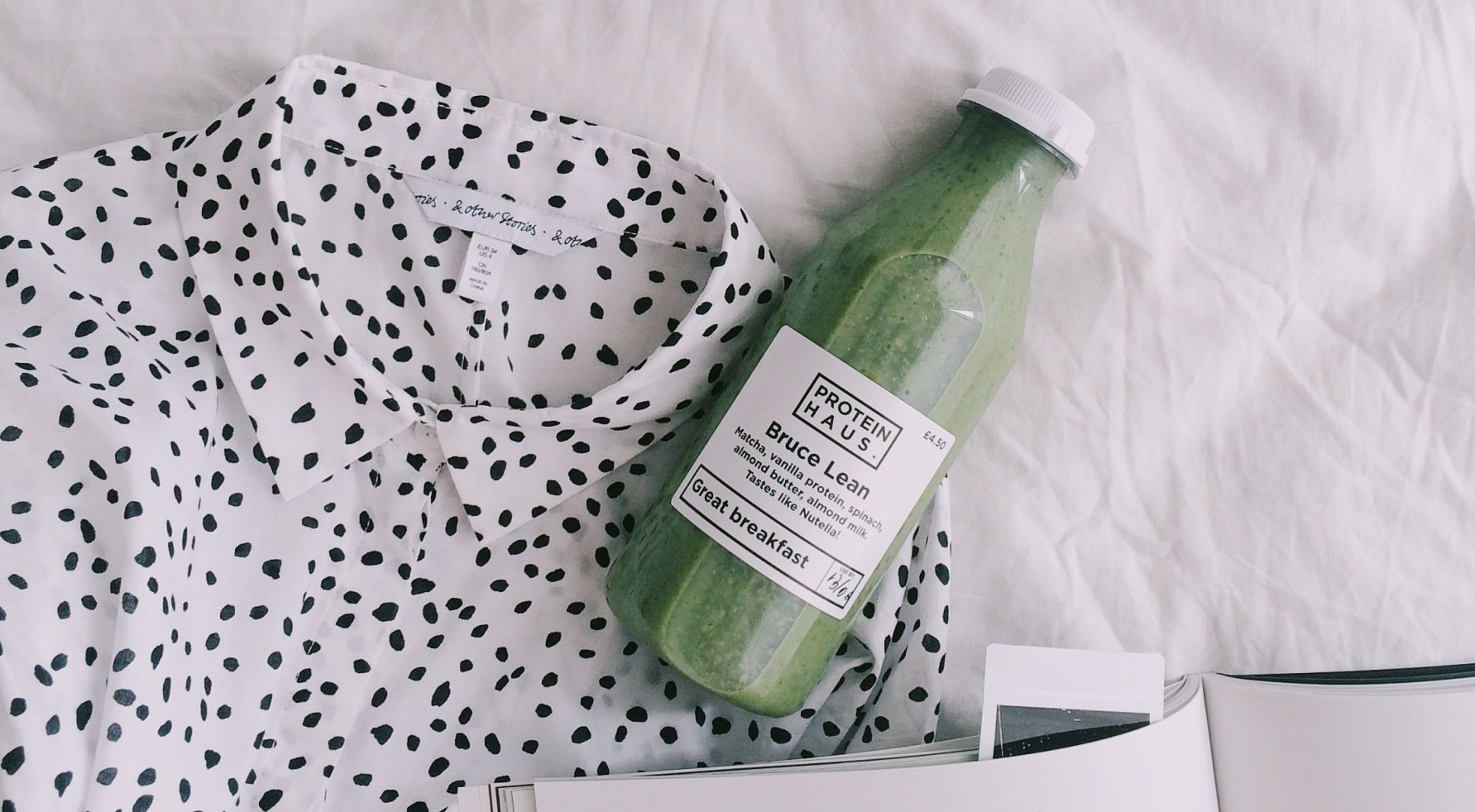 Bottle of breakfast CBD juice next to a polka-dotted shirt.