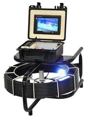 a camera is sitting on top of a hose on a table .