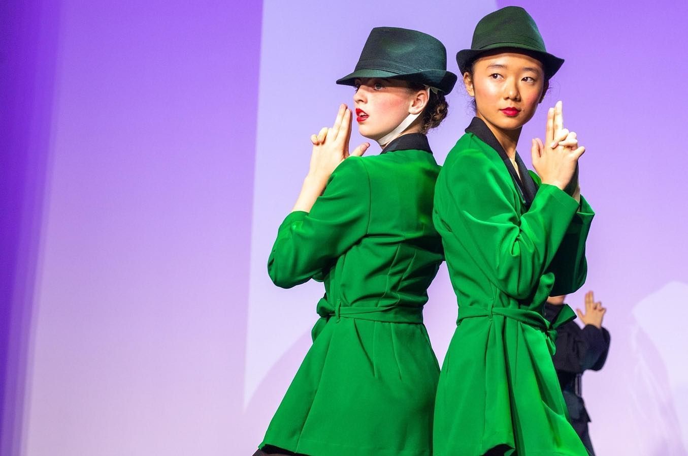 Two Dancers in Green Jackets and Hats, Posing With Hands as Guns — Kay Flynn Dancing Academy Southport in Southport, QLD