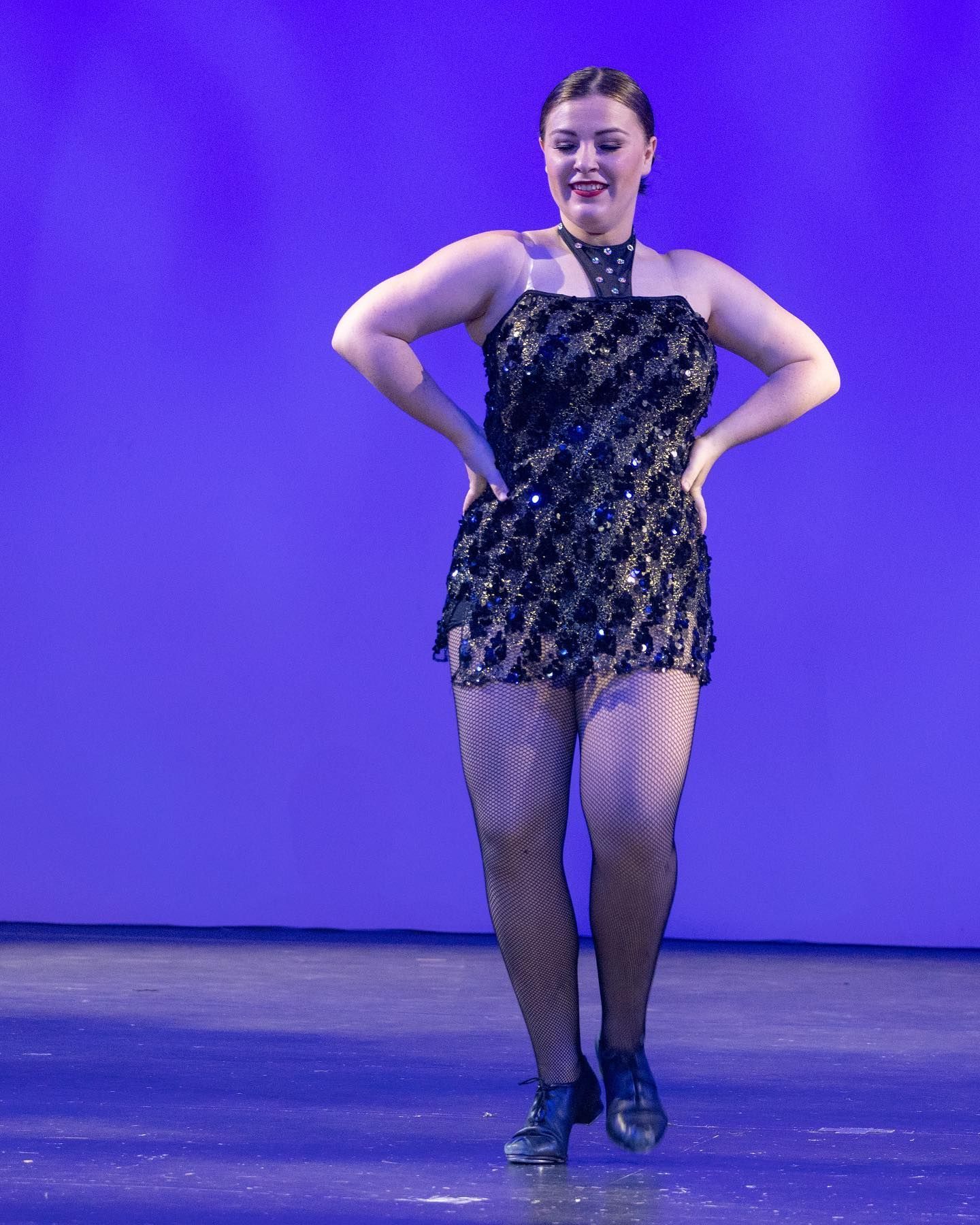 Dancer on Stage in Black Sequined Dress, Fishnets, and Tap Shoes — Kay Flynn Dancing Academy Southport in Southport, QLD