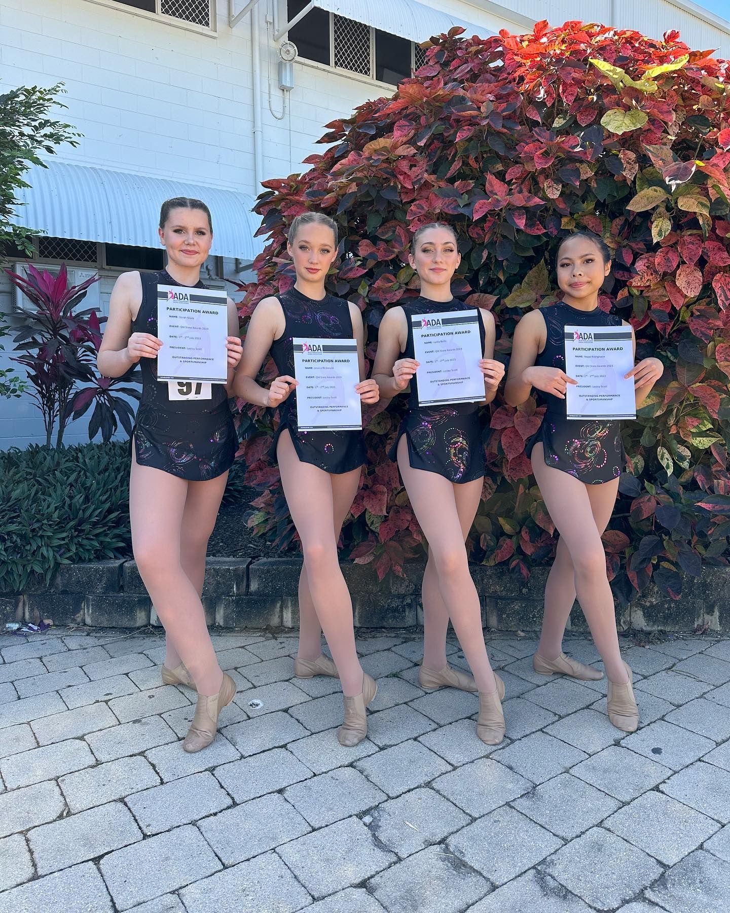 Four Young Dancers in Black Costumes Hold Certificates — Kay Flynn Dancing Academy Southport in Southport, QLD