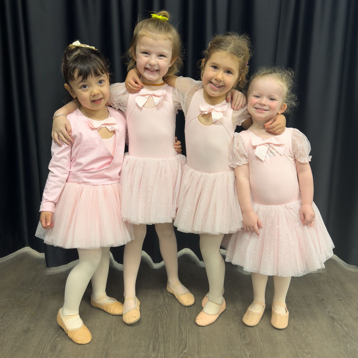Four Young Girls in Pink Ballet Attire, Smiling and Posing — Kay Flynn Dancing Academy Southport in Southport, QLD