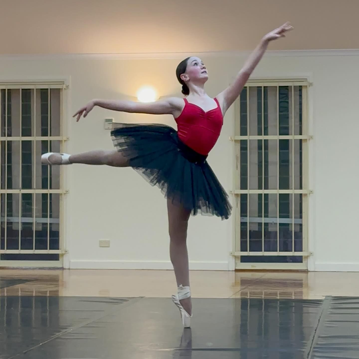 Ballet Dancer in Red Leotard and Black Tutu Performs a Graceful Pose — Kay Flynn Dancing Academy Southport in Southport, QLD
