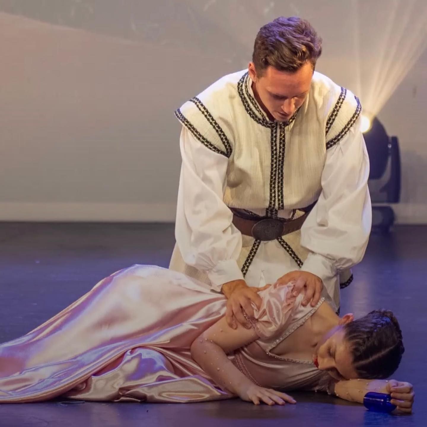 Man Kneels, Comforting Woman in Pink Dress, on a Stage — Kay Flynn Dancing Academy Southport in Southport, QLD