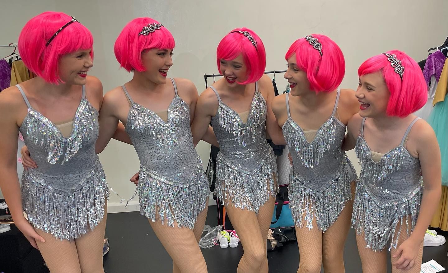 Five Dancers in Silver Fringed Dresses and Pink Wigs Laugh — Kay Flynn Dancing Academy Southport in Southport, QLD
