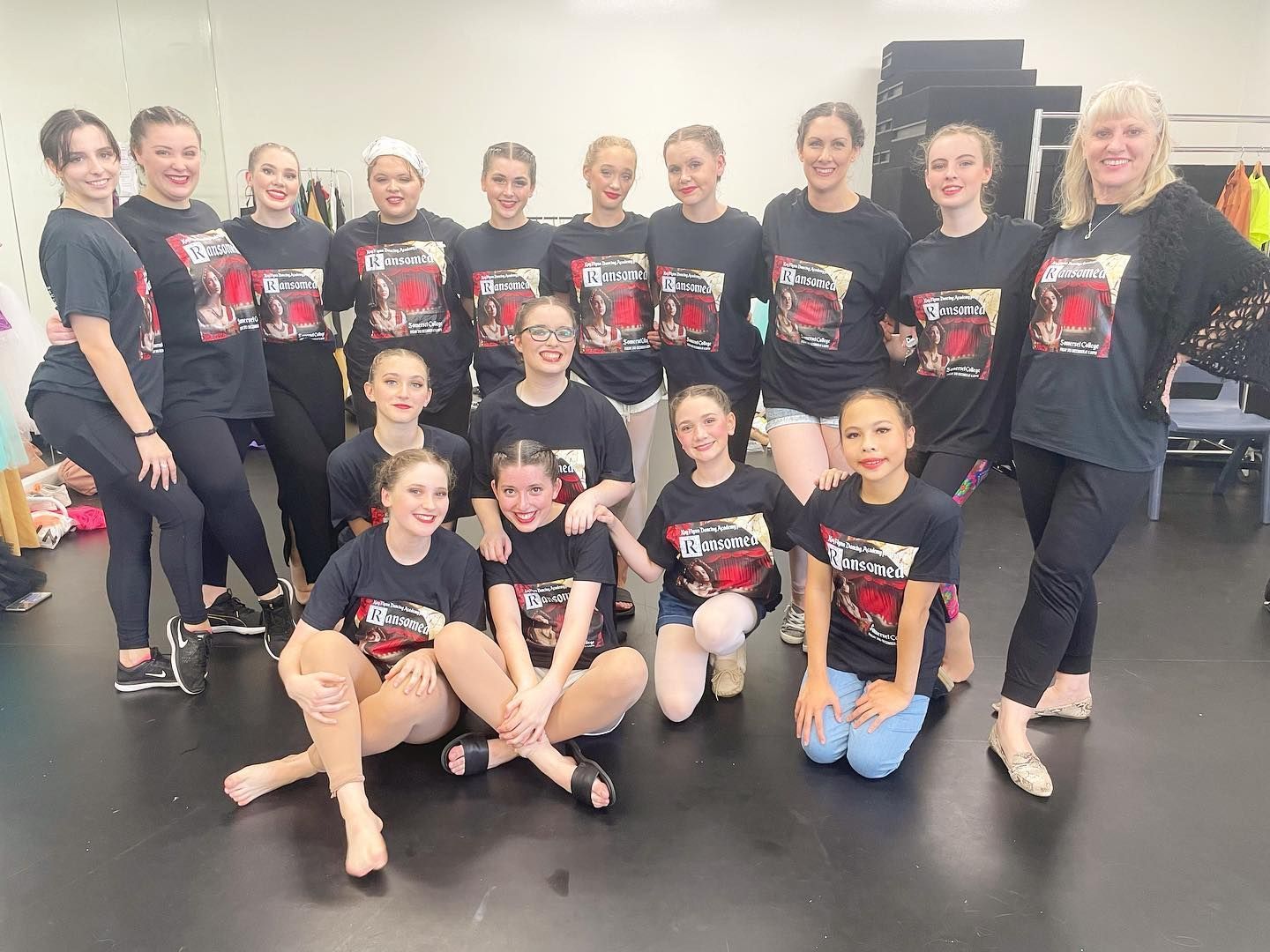 Group of Dancers in Black T-shirts Pose in a Dance Studio, Smiling — Kay Flynn Dancing Academy Southport in Southport, QLD