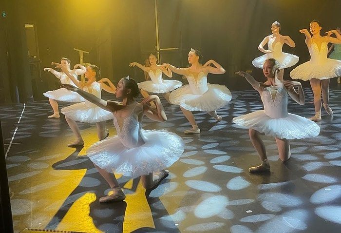 A Group of Young Ballerinas in White Tutus Perform on a Stage — Kay Flynn Dancing Academy Southport in Southport, QLD