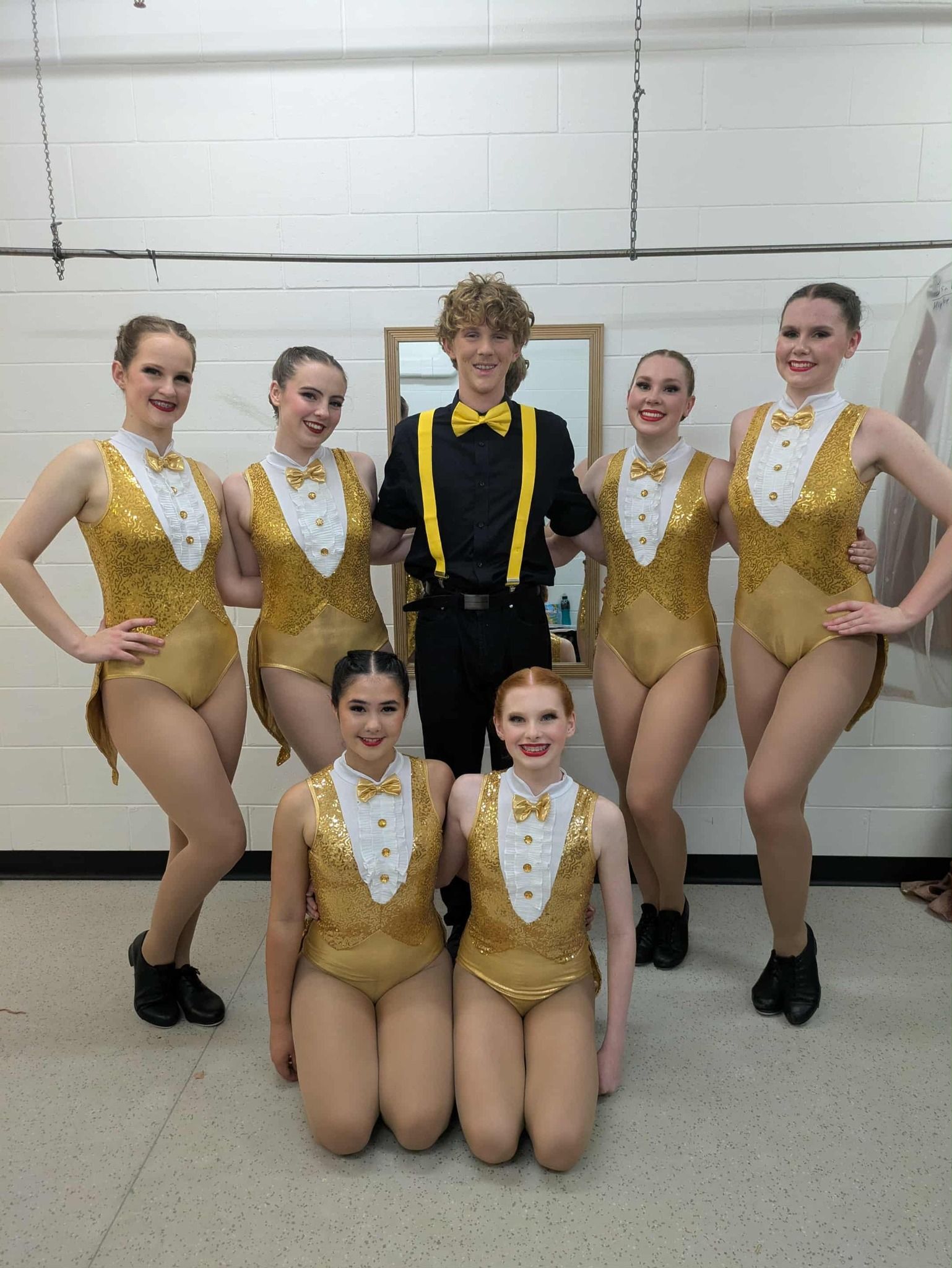 A Group of Dancers in Gold Sequin Leotards Pose — Kay Flynn Dancing Academy Southport in Southport, QLD