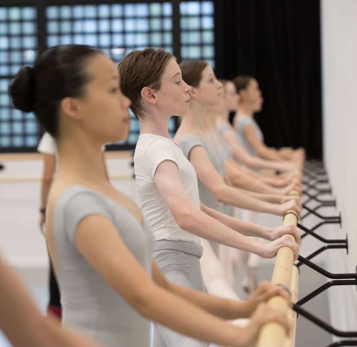 Ballet Dancers in Grey Leotards at the Barre, Practicing in a Studio — Kay Flynn Dancing Academy Southport in Southport, QLD