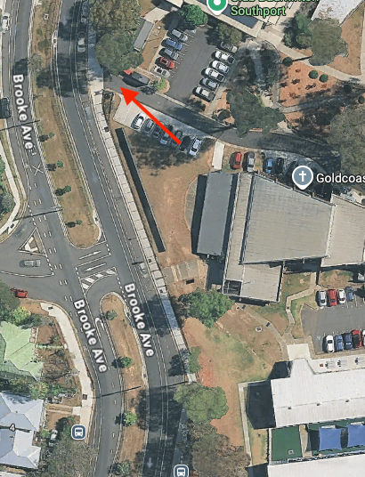 Aerial view of Brooke Ave, Gold Coast, Australia. Red arrow indicates the direction of vehicle exit from a parking lot. — Kay Flynn Dancing Academy Southport in Southport, QLD