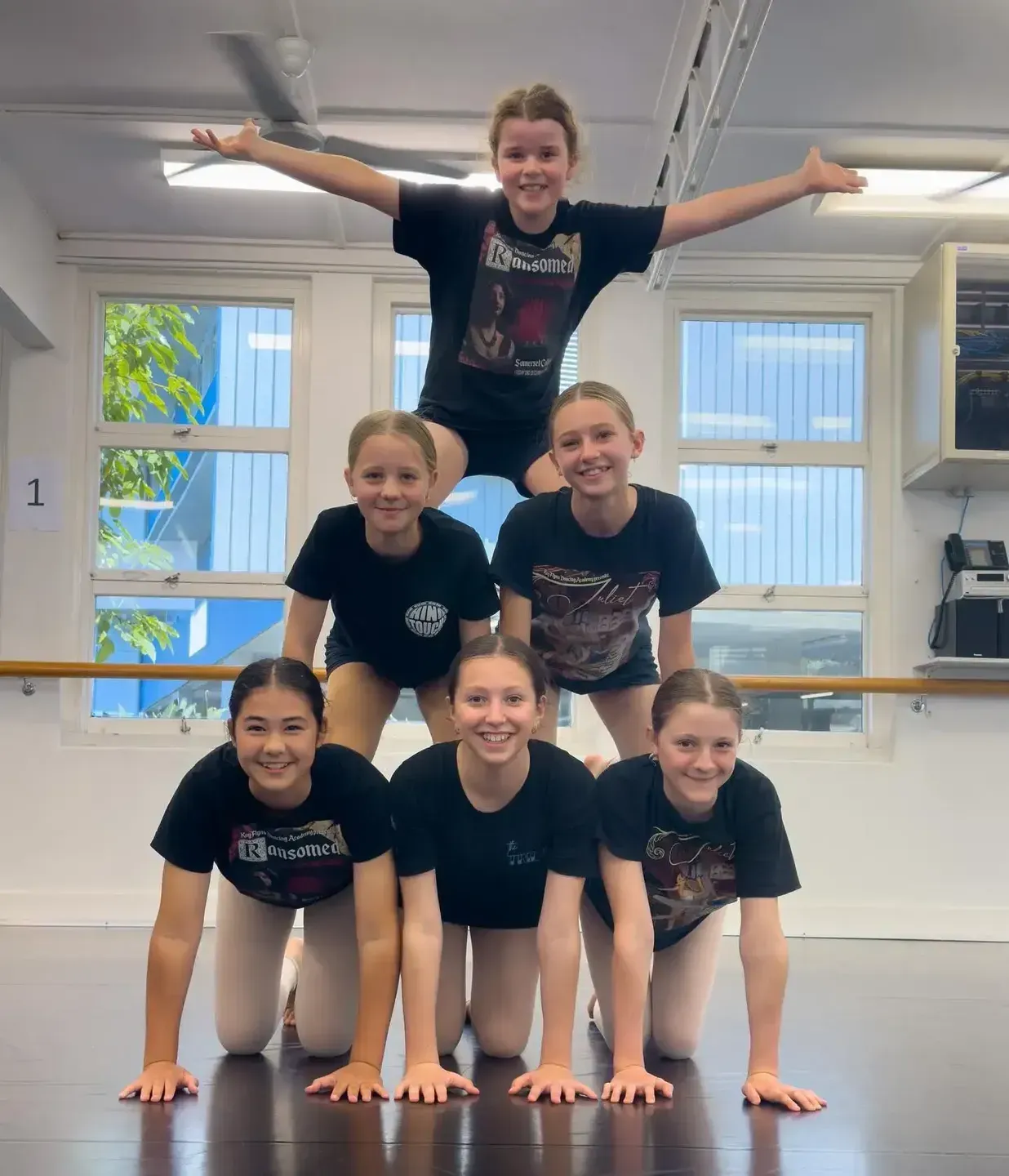 Group of Children Forming a Human Pyramid in a Dance Studio — Kay Flynn Dancing Academy Southport in Southport, QLD