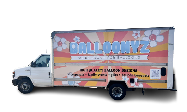White delivery truck with BALLOONYZ branding, floral graphics, and text advertising balloon designs. White delivery truck with BALLOONYZ branding, floral graphics, and text advertising balloon designs.