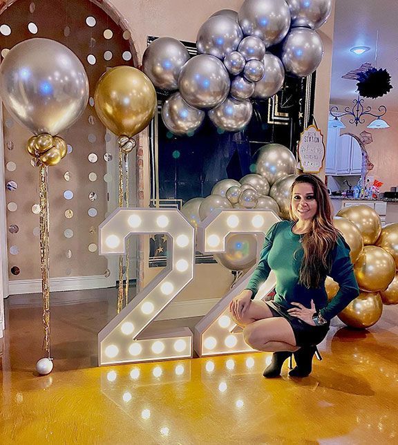 Woman poses near illuminated