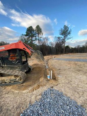 A bulldozer is digging a hole in the dirt on a construction site.