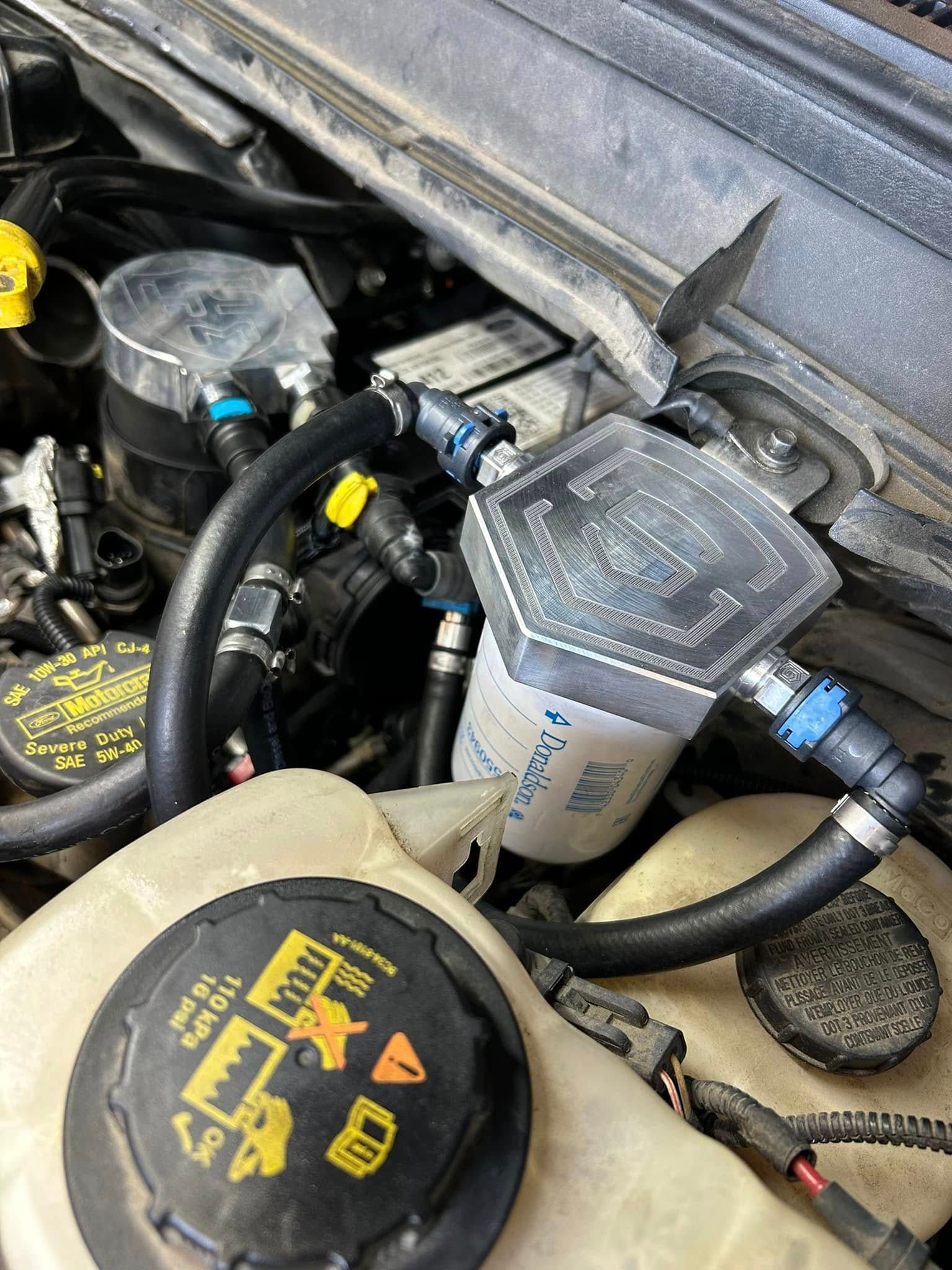 A close up of a car engine with a cap on it.